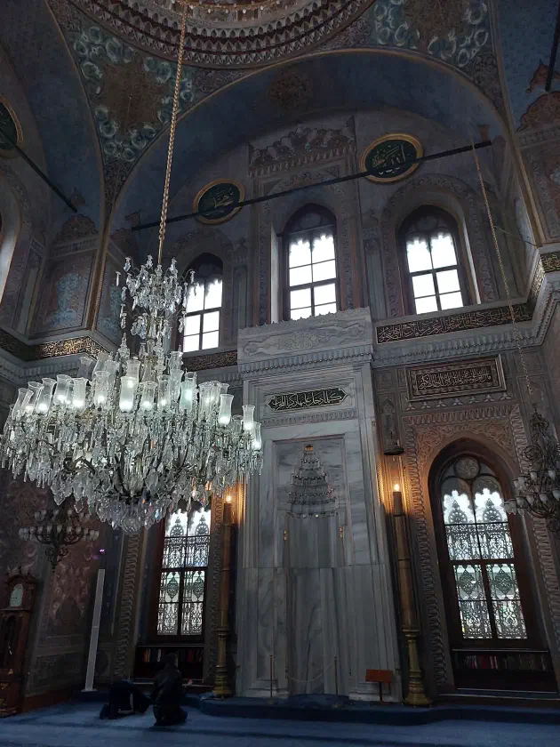 Inside Pertevniyal — chandelier and mihrab